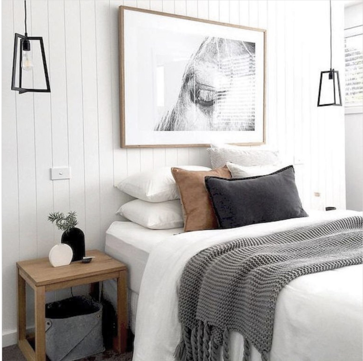 Shiplap Wall With Gaint Art Work Behind The Bed